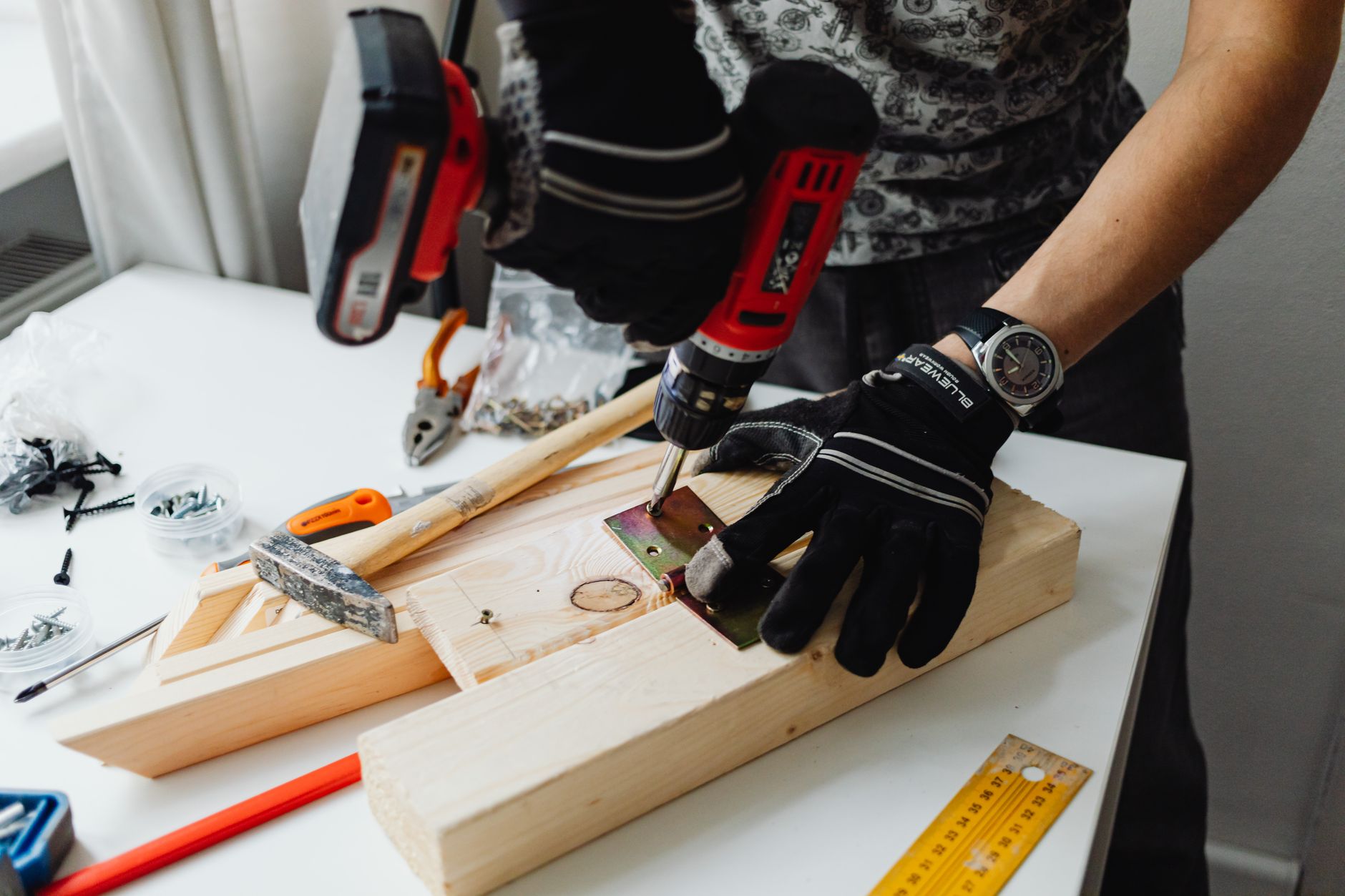 A craftsman uses a power drill on wood, showcasing carpentry tools and skills. — "Windows of Fort Lauderdale: Where Style Mee